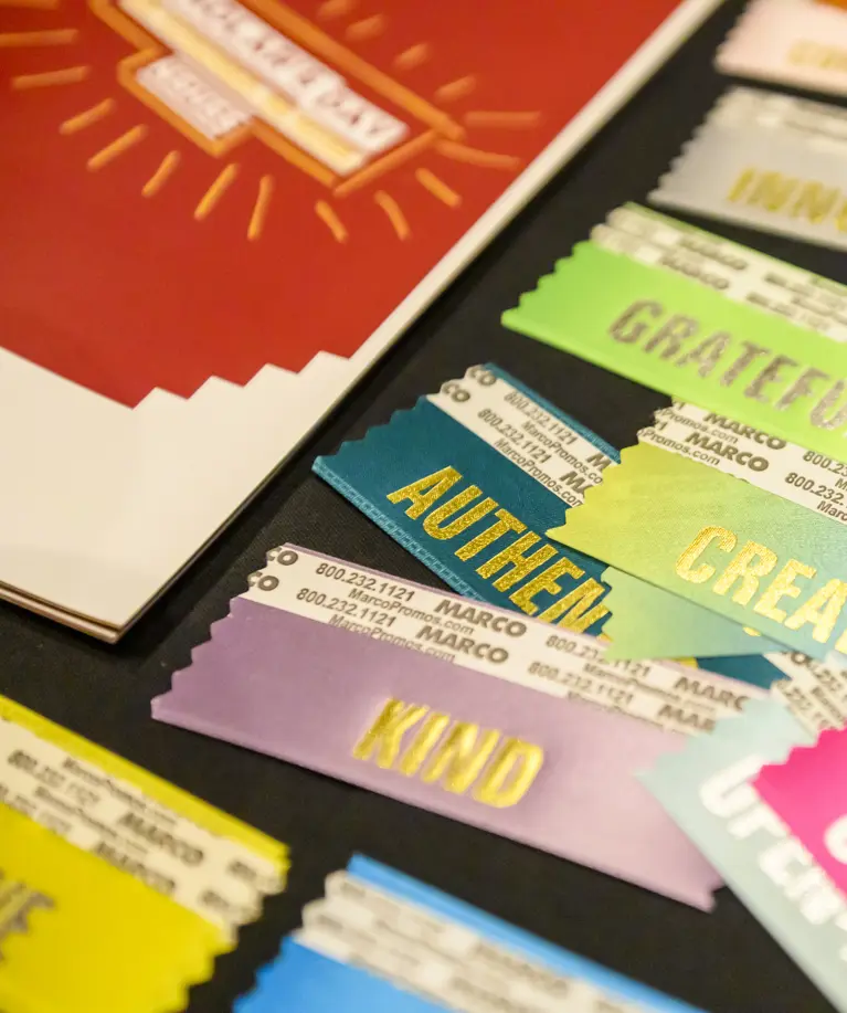 Be More ribbons next to Scholar's Day program