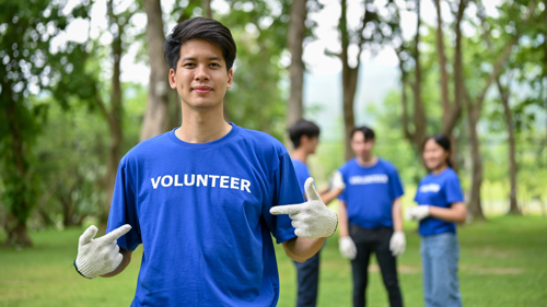 Volunteer facing the camera with other volunteers in background