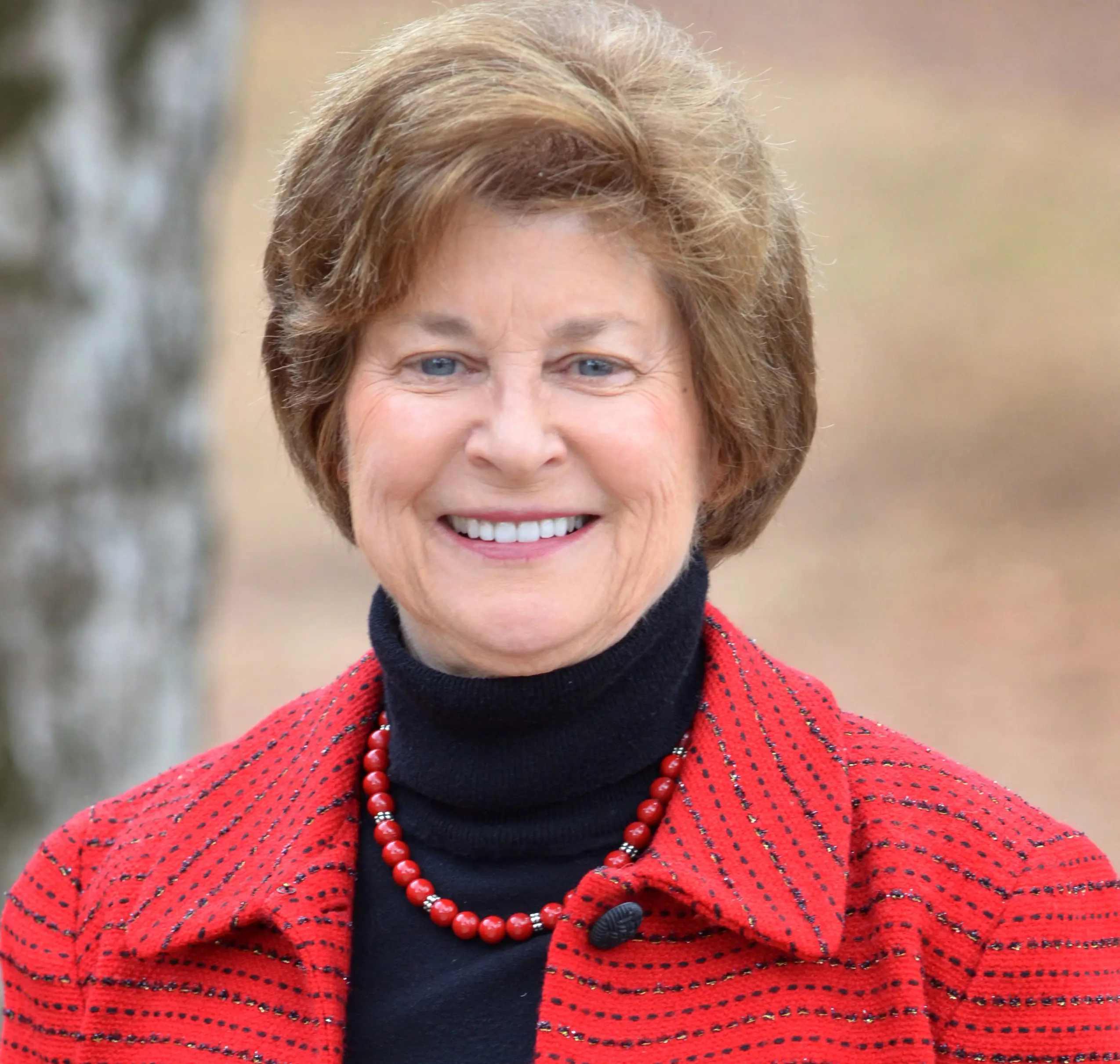 An older woman  named Nancy Beane with blond hair smiling