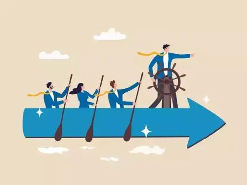 Team rowing an arrow-shaped boat led by a person steering and pointing ahead, symbolizing leadership and direction
